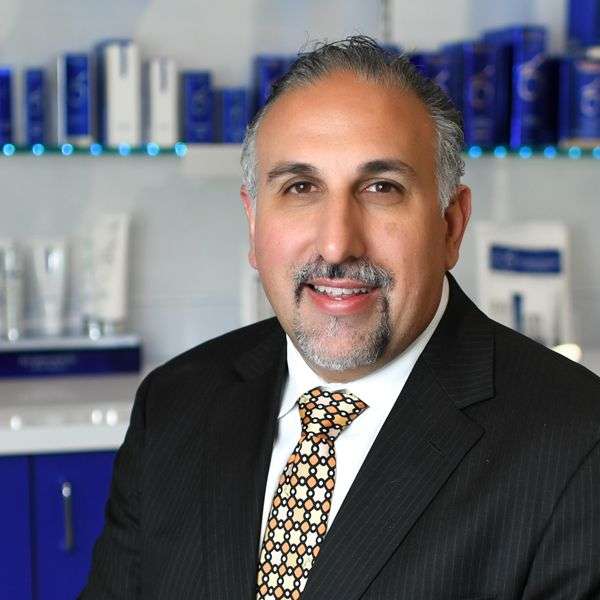 Dr. Mark Khorsandi Head Shot in front of ZO Skin Health Products at ZO Skin Centre Houston